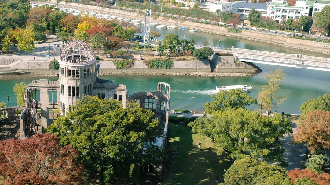 Hiroshima Peace Memorial with river and boat, view from above.