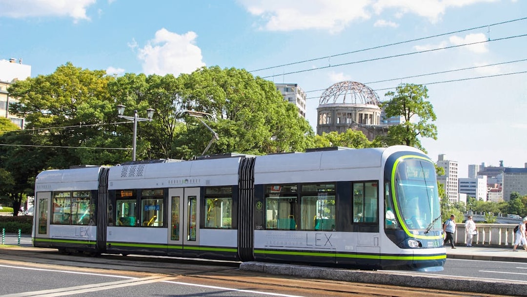 Tram passing by Hiroshima Peace Memorial in Hiroshima, Japan.