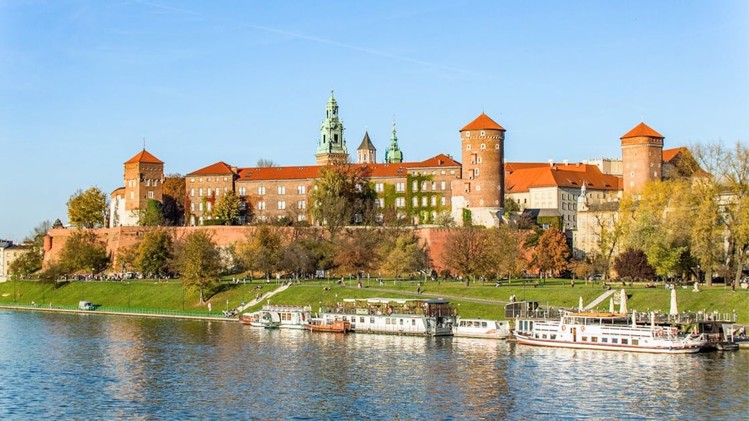 Catamaran on Vistula River with Wawel Castle in Krakow in the background.