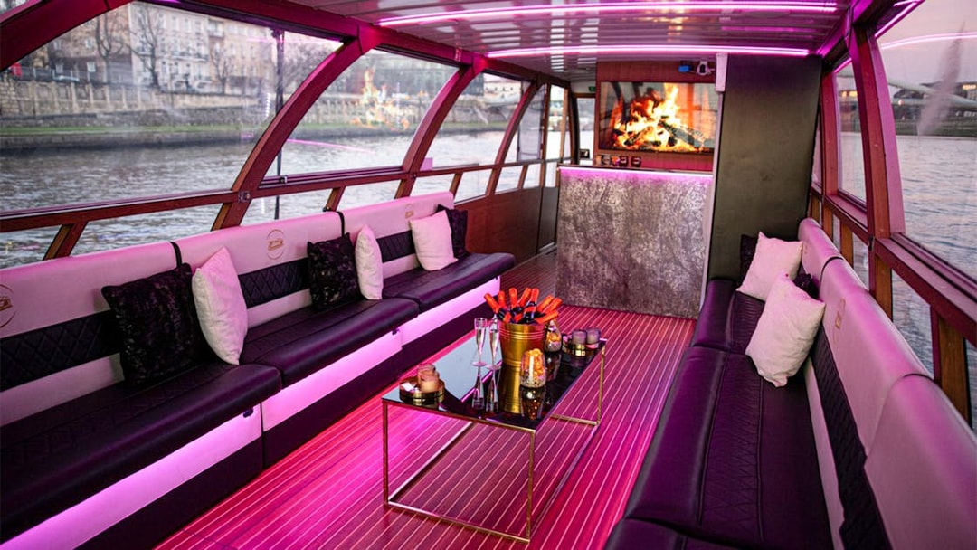 Interior of the Vistula River Cruise catamaran in Krakow with seating and a fireplace.