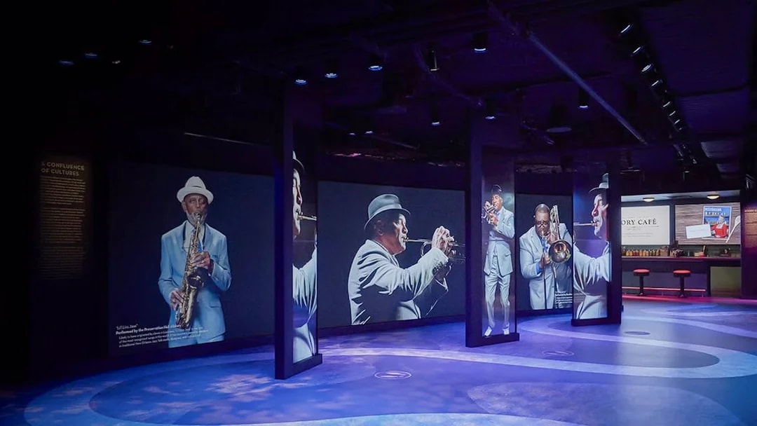 Musicians displayed on digital screens at Vue Orleans Observation Deck.