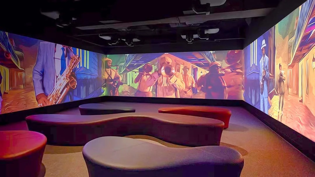 Vue Orleans Observation Deck interior with vibrant jazz-themed wall projections.