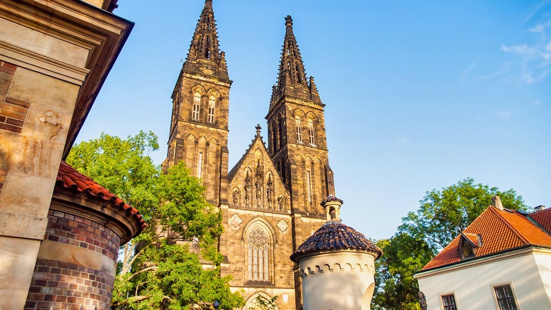 Vyšehrad Castle's twin spires and surrounding architecture in Prague.