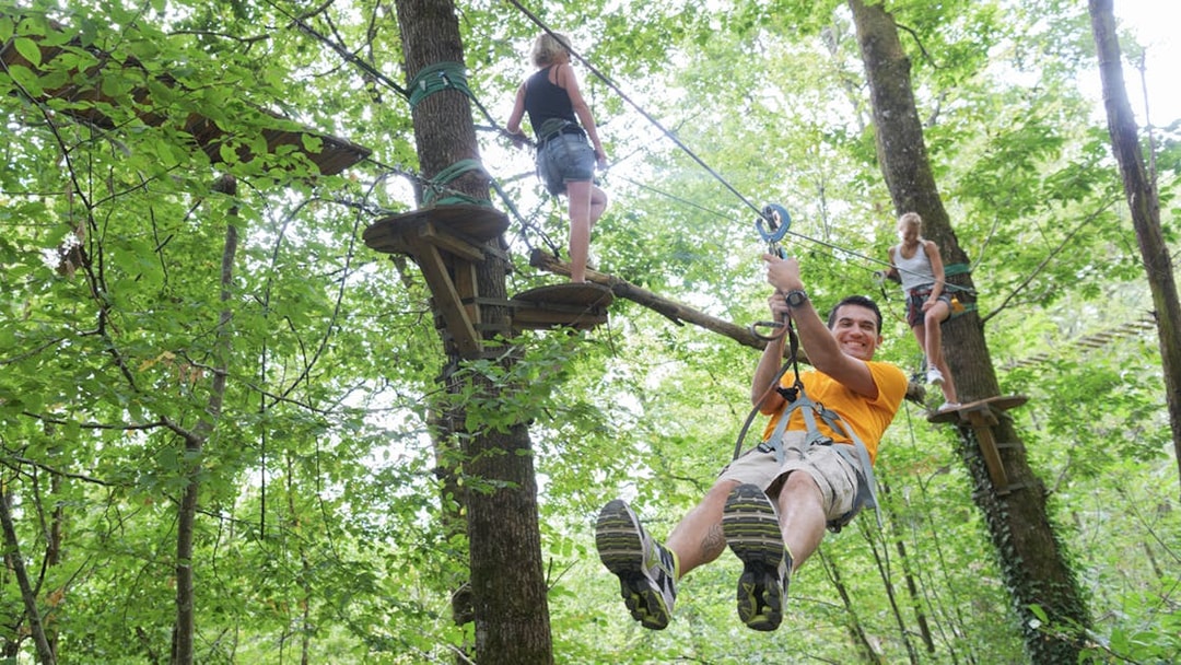 People ziplining through trees at Hanuman World Phuket.