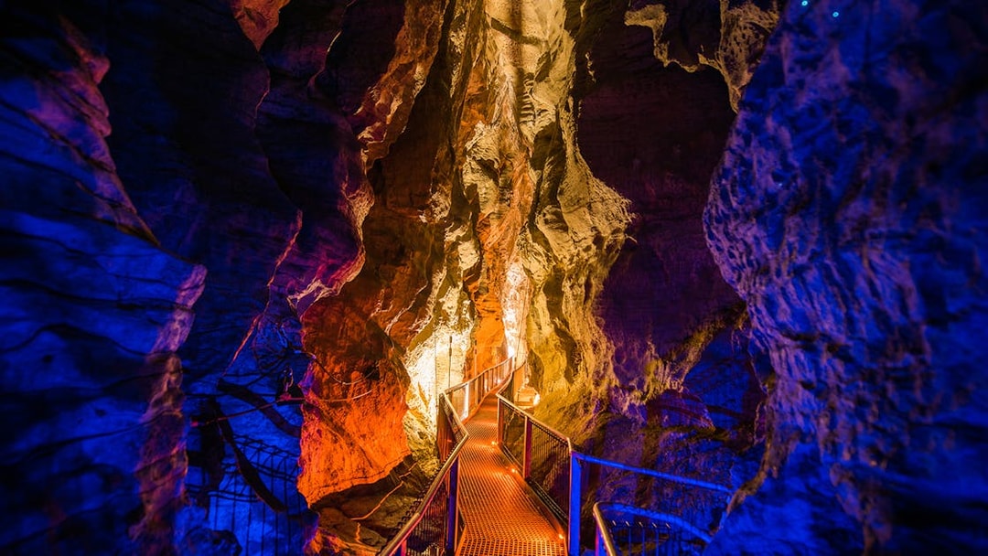 Walkway through illuminated Waitomo Glowworm Caves, New Zealand.