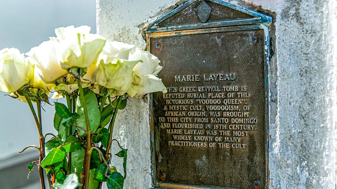 Tomb of Marie Laveau with white roses in St. Louis Cemetery, New Orleans.