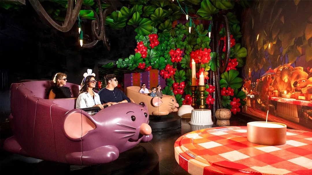 Guests enjoying Ratatouille ride at Walt Disney World Resort, Orlando, surrounded by vibrant decor.