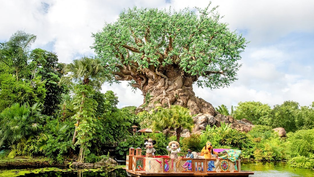 Characters on a boat in front of the Tree of Life at Animal Kingdom, Orlando.