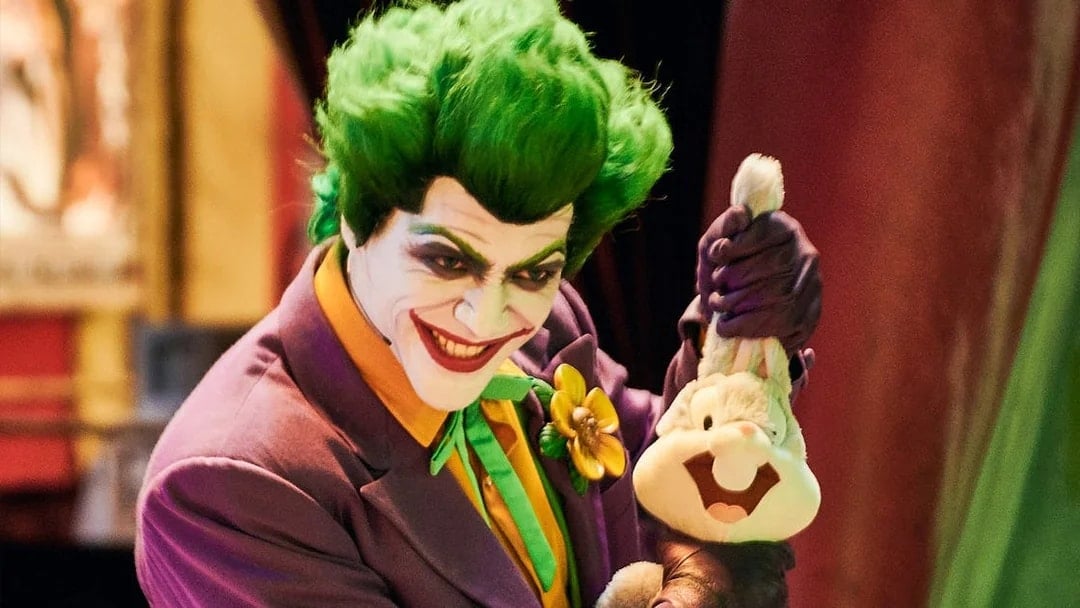 Character in colorful costume holding a plush toy at Warner Bros. World Abu Dhabi.