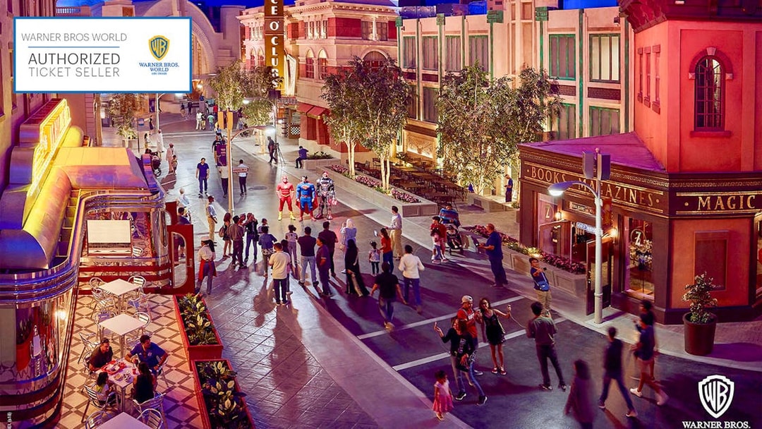 Visitors at Warner Bros. World Abu Dhabi interacting with costumed characters on a themed street.
