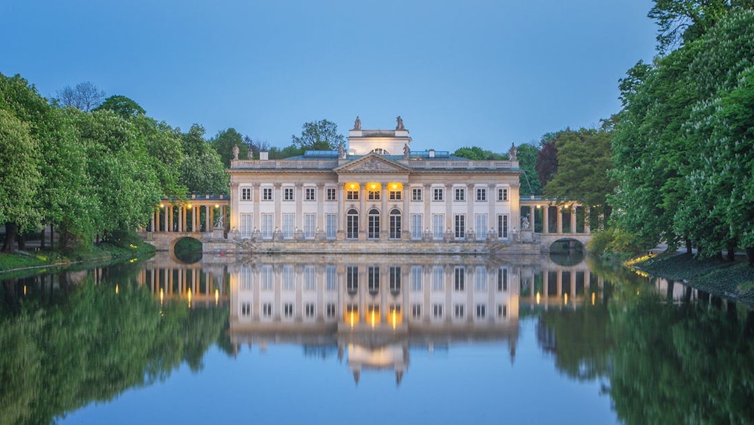 Lazienki Palace reflecting on water in Warsaw, Poland, included in Warsaw Pass.