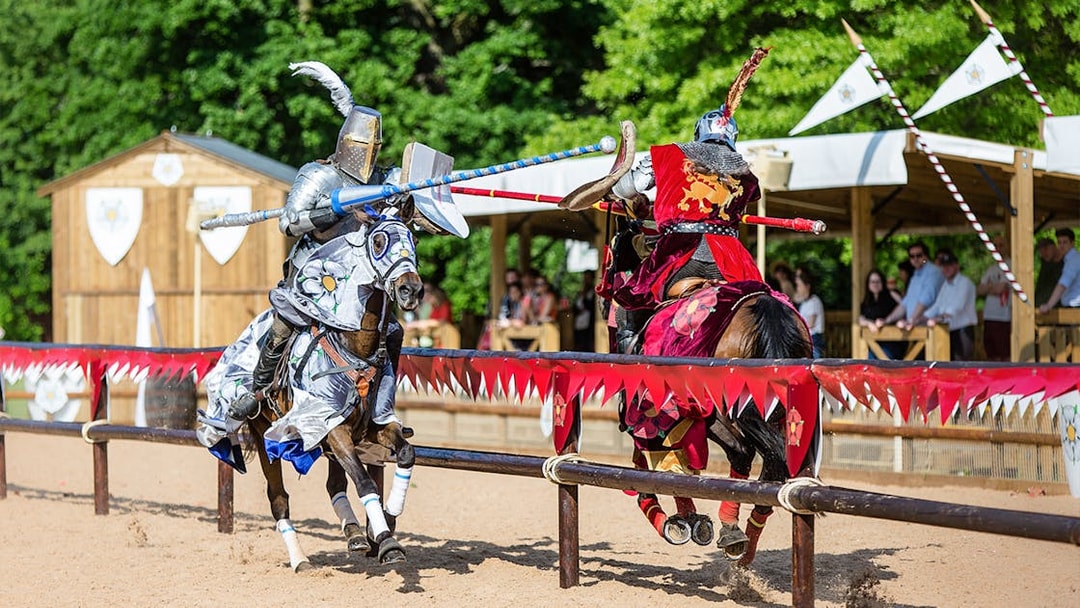 Jousting knights on horseback at Warwick Castle event.