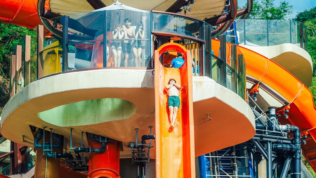 Person sliding down orange waterslide at Water World Ocean Park, Hong Kong.