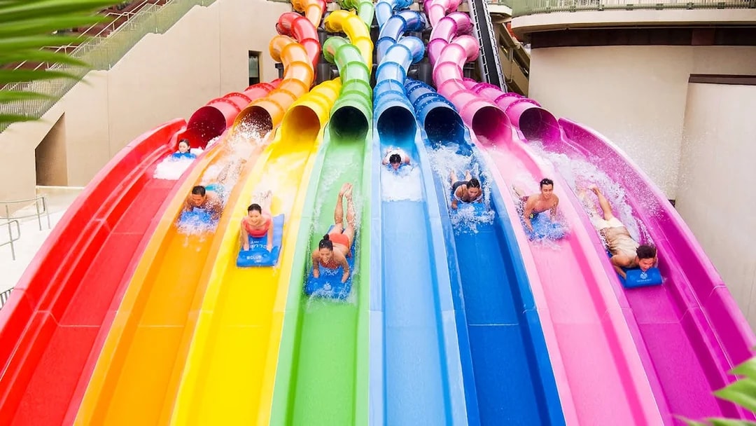 Visitors enjoying colorful water slides at Water World Ocean Park Hong Kong.