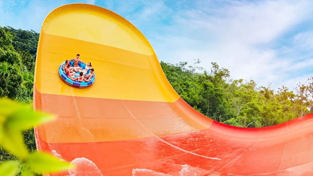 People enjoying a large waterslide at Water World Ocean Park, Hong Kong.