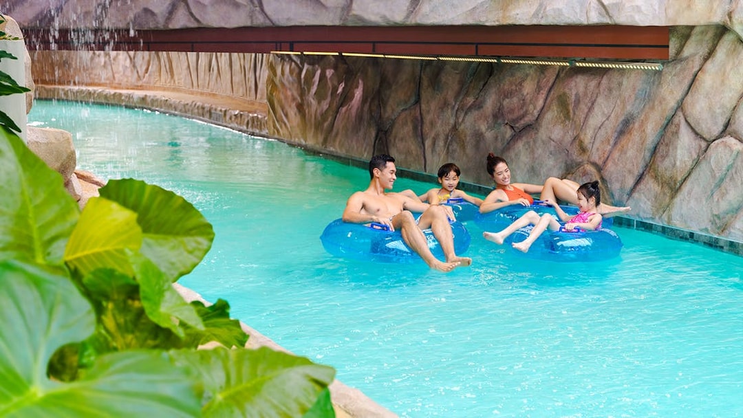 Family enjoying lazy river at Water World Ocean Park, Hong Kong.