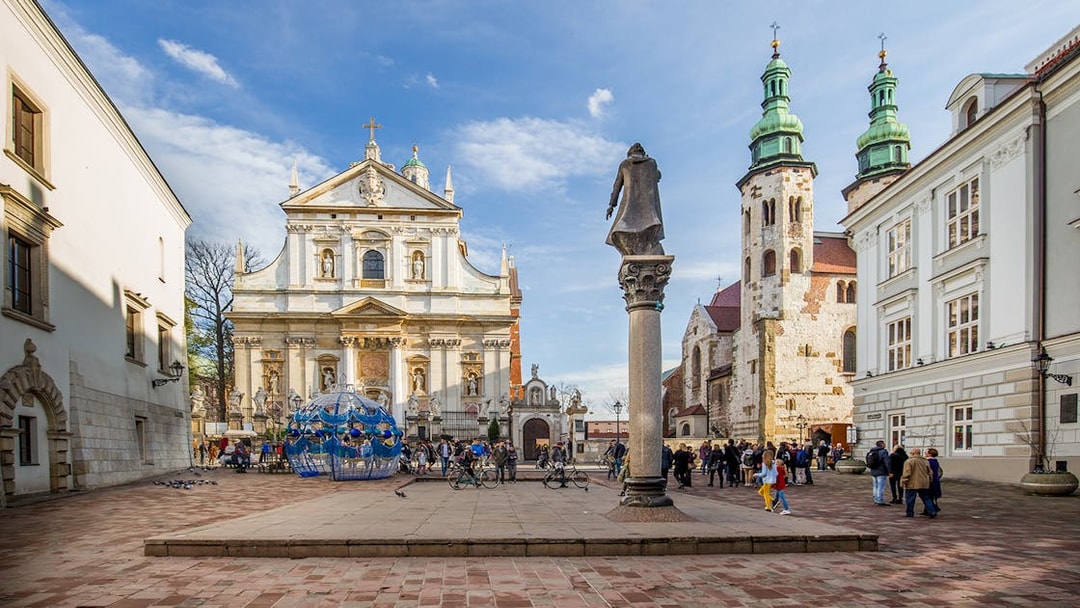 Tourists exploring Krakow's old town near Saints Peter and Paul Church.