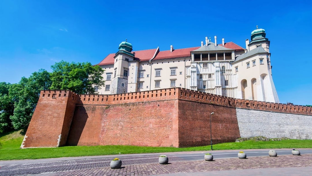 Wawel Castle on Wawel Hill, Krakow, viewed from below with red brick walls.