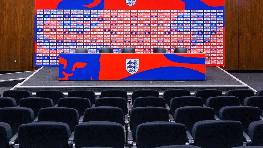 Press conference area with seating and backdrop at Wembley Stadium.