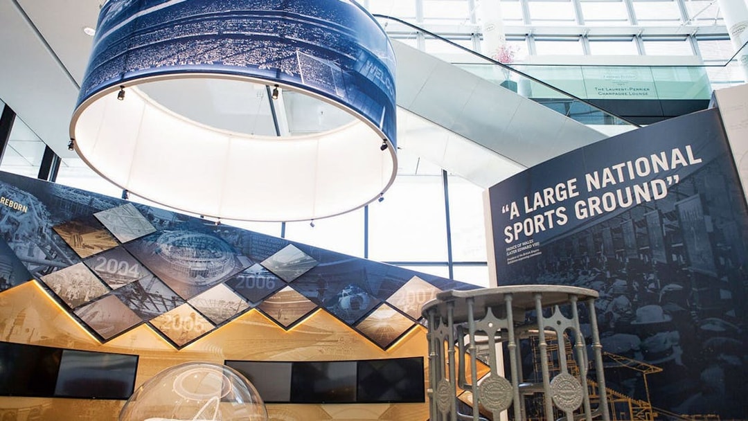 Wembley Stadium interior exhibit with historical timeline and sports memorabilia.