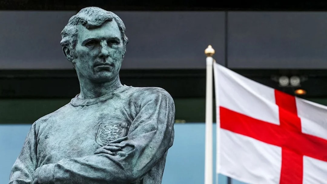 Statue of Bobby Moore with England flag at Wembley Stadium.