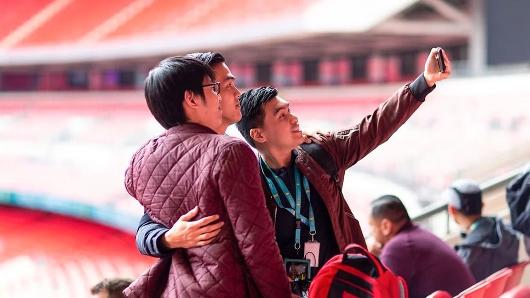 Visitors taking a selfie inside Wembley Stadium.