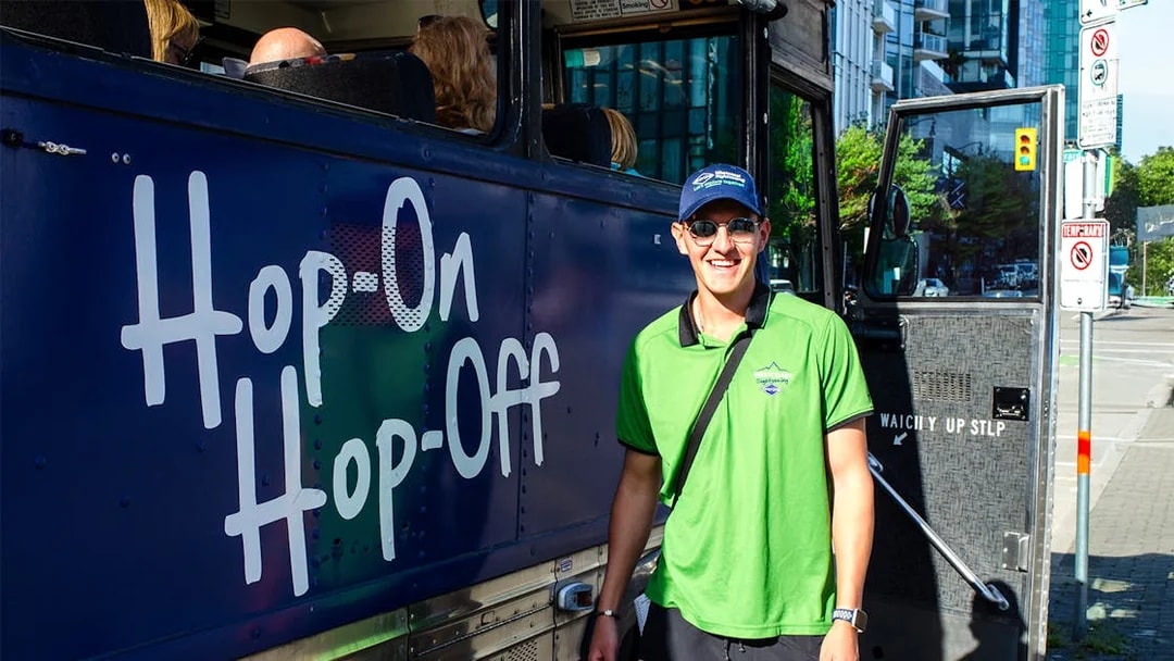 Hop on Hop off tour bus crew member in Vancouver city.