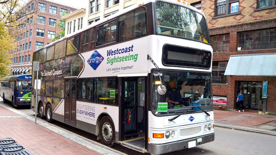 Gray Line hop-on hop-off bus parked on a street in Vancouver.