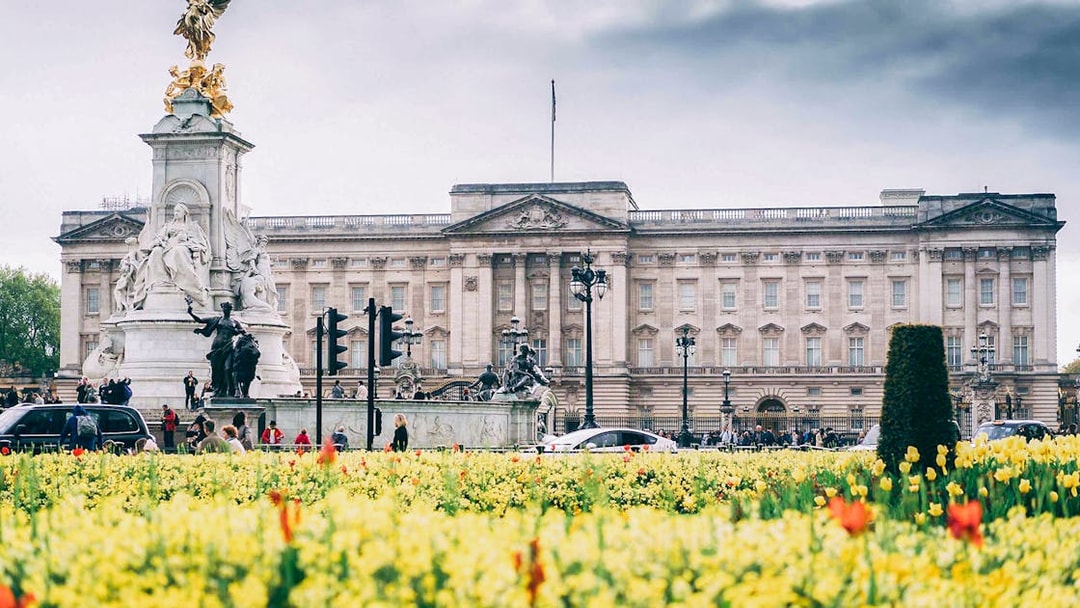 Buckingham Palace with Victoria Memorial and blooming flowers, part of Tower Bridge & Westminster Walking Tour.