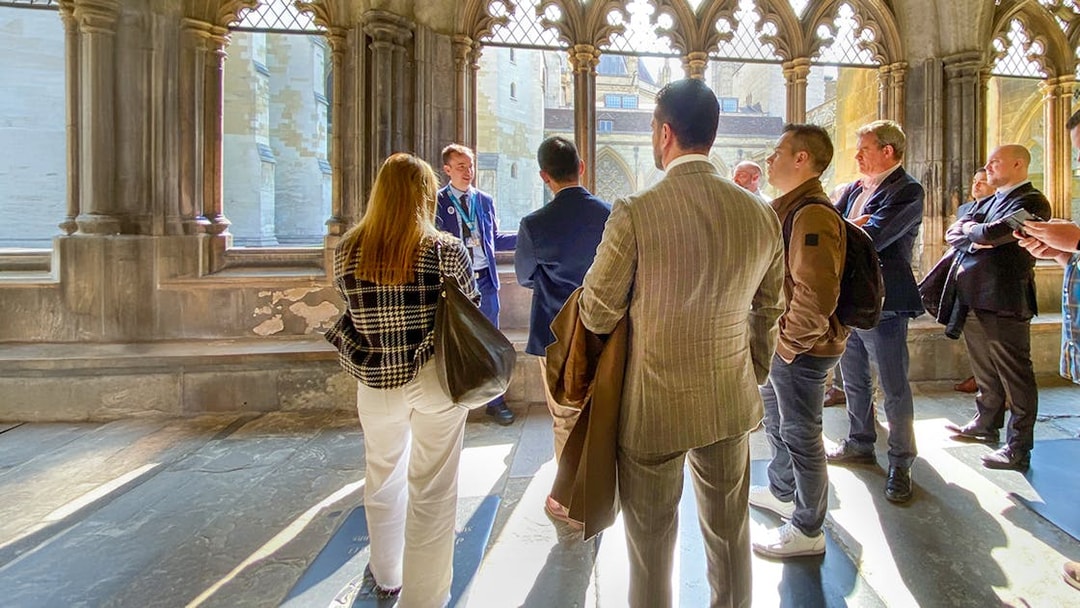 Tourists listening to a guide inside Westminster Abbey, London.