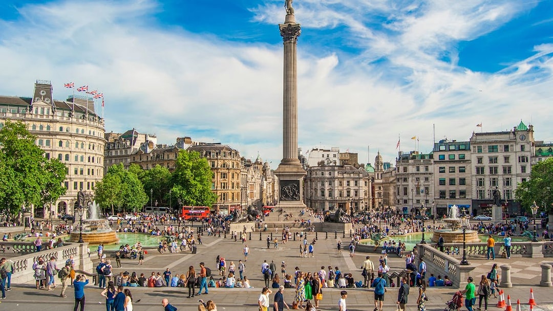 Tourists at Trafalgar Square with Nelson's Column during Westminster walking tour.