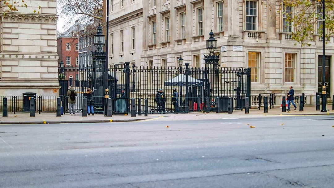 Entrance to Downing Street, London, with security and historic buildings visible.