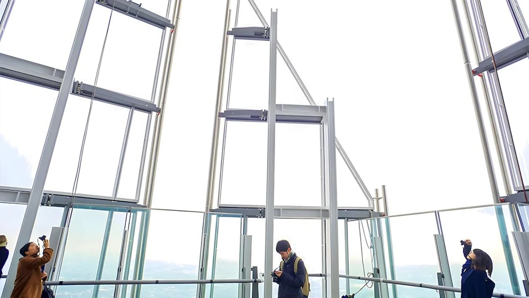 Visitors enjoying the view from The Shard's observation deck in London.