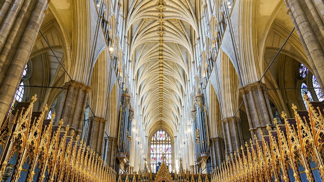 Interior of the coronation church with ornate arches and golden details, London, UK.