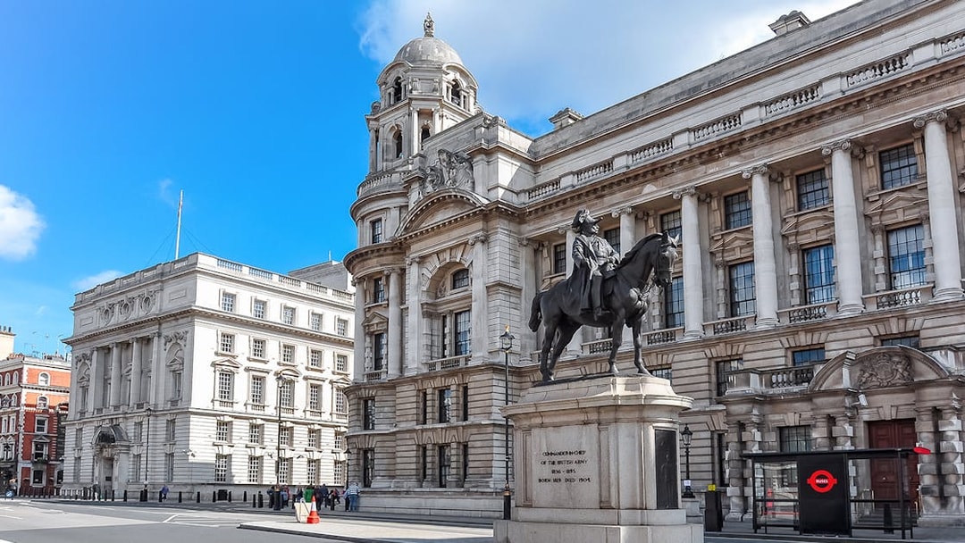 Equestrian statue in front of historic London building near Westminster.