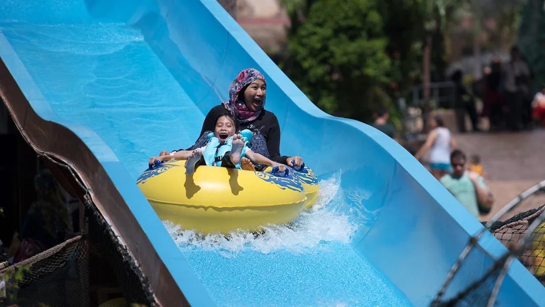 Family enjoying a water slide at Wet World Water Park Shah Alam.