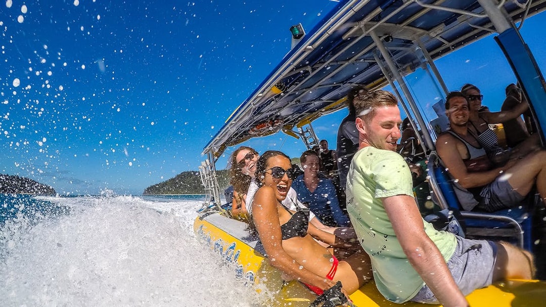 Group enjoying a speedboat ride in the Whitsundays, part of the Fly + Raft Package.