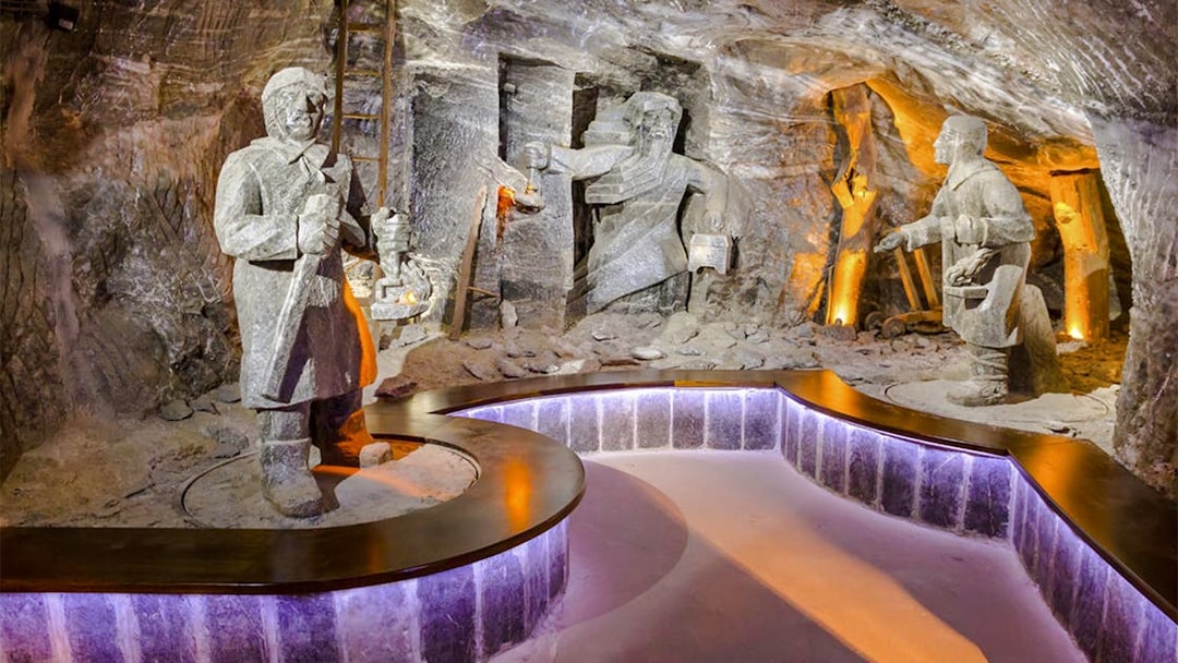 Wieliczka Salt Mine sculptures depicting miners with tools and lanterns.