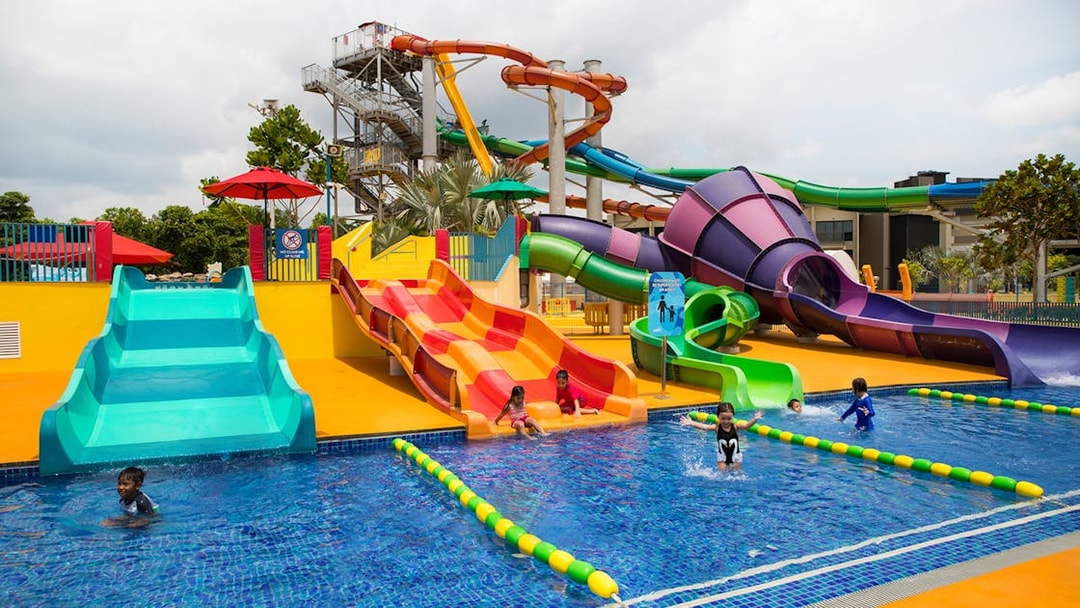 Children playing on colorful water slides at Wild Wild Wet, Singapore.