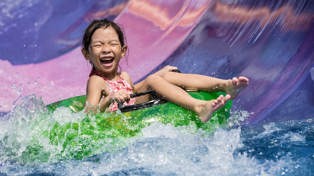 Girl on water slide at Wild Wild Wet Singapore.