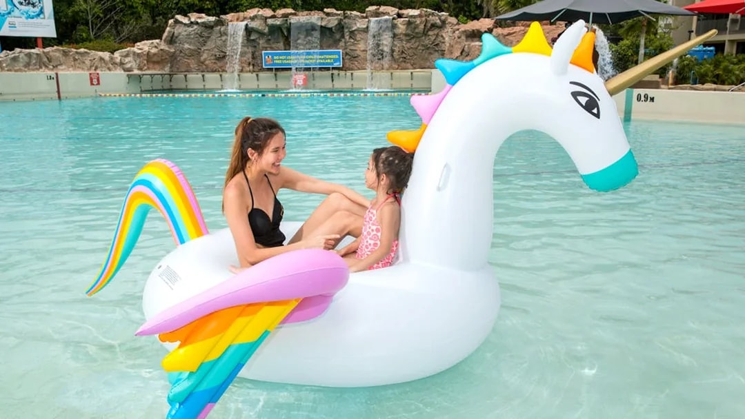 Children on unicorn float at Singapore Wild Wild Wet water park.