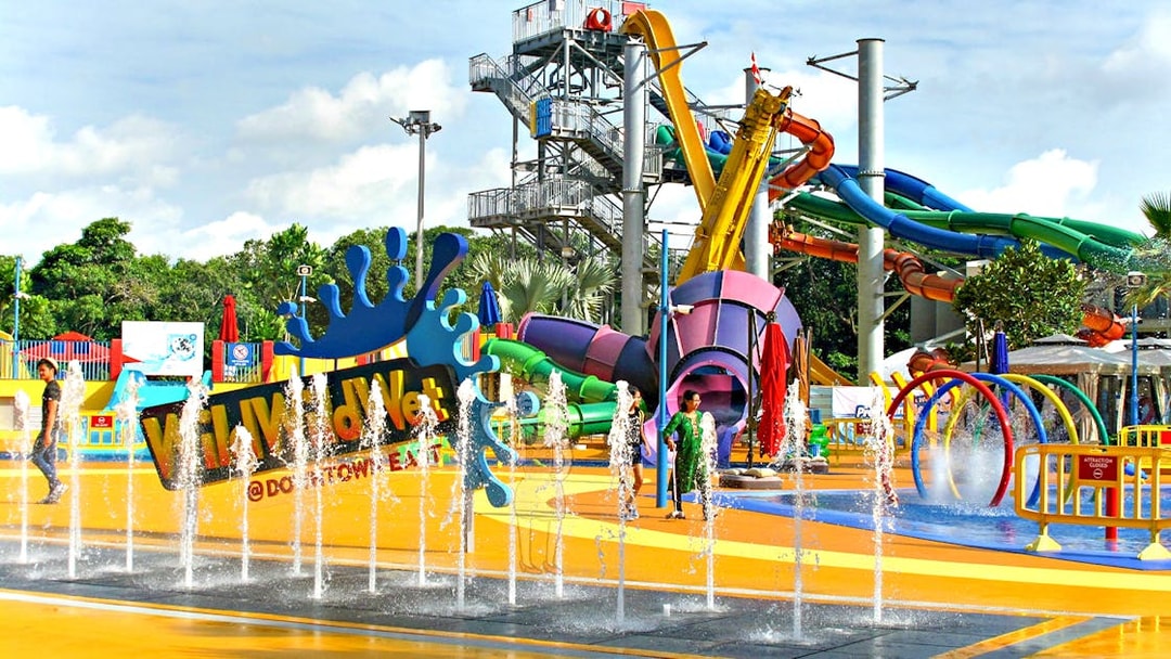 Wild Wild Wet water park entrance with colorful slides and splash fountains in Singapore.