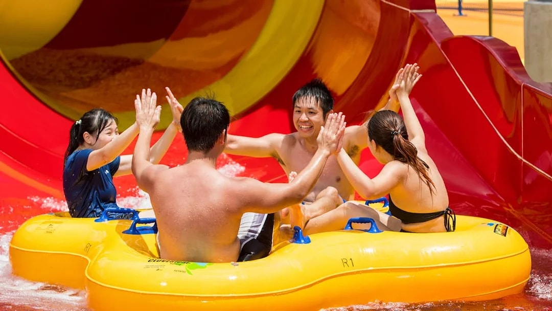 Group enjoying a water slide ride at Singapore's Wild Wild Wet.