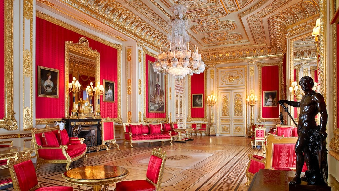 Crimson Drawing Room in Windsor Castle with ornate gold decor and chandeliers.