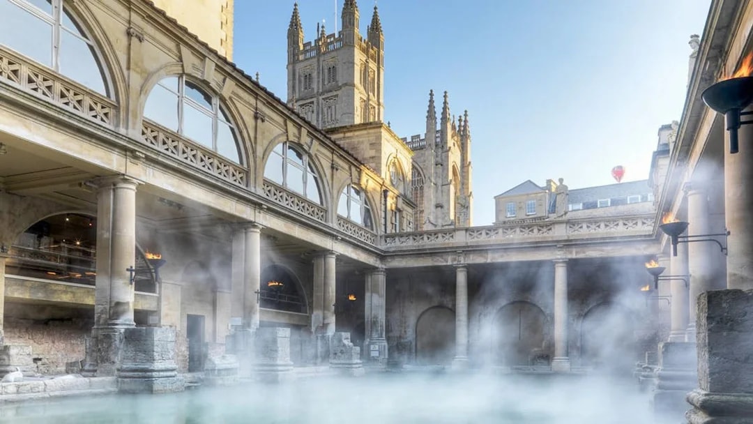 Roman Baths in Bath with steam rising, part of a day trip from London including Stonehenge and Windsor Castle.