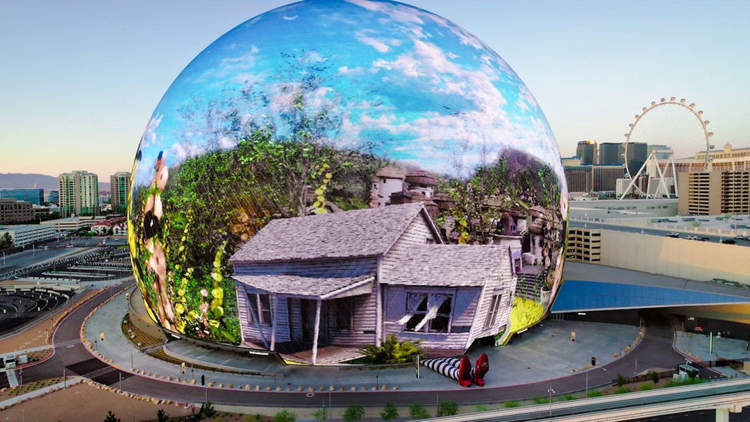 Sphere in Las Vegas displaying Wizard of Oz scene with house and ruby slippers.