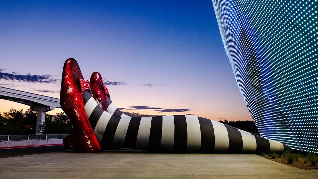 Giant striped legs with red shoes at Sphere, Wizard of Oz theme.