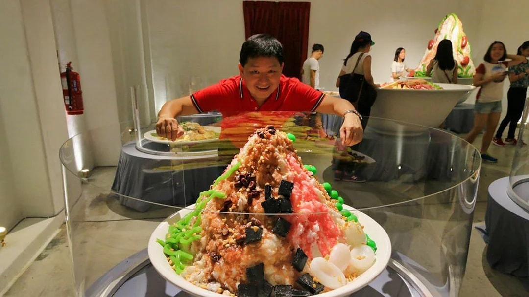 Man admiring large dessert display at Wonderfood Museum.