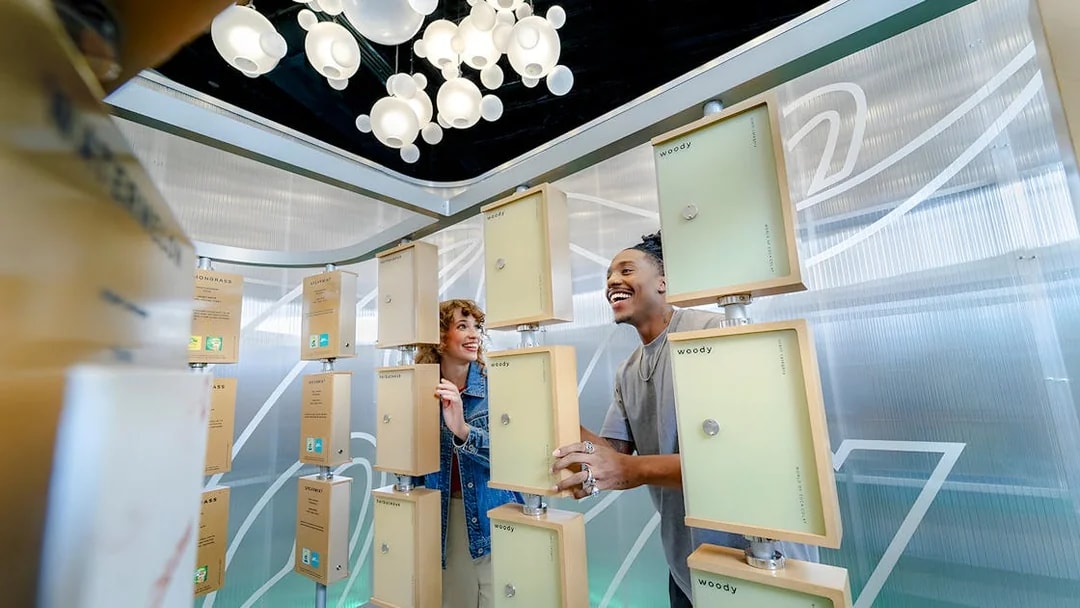 Friends exploring scent display at World of Coca-Cola Museum, Atlanta.