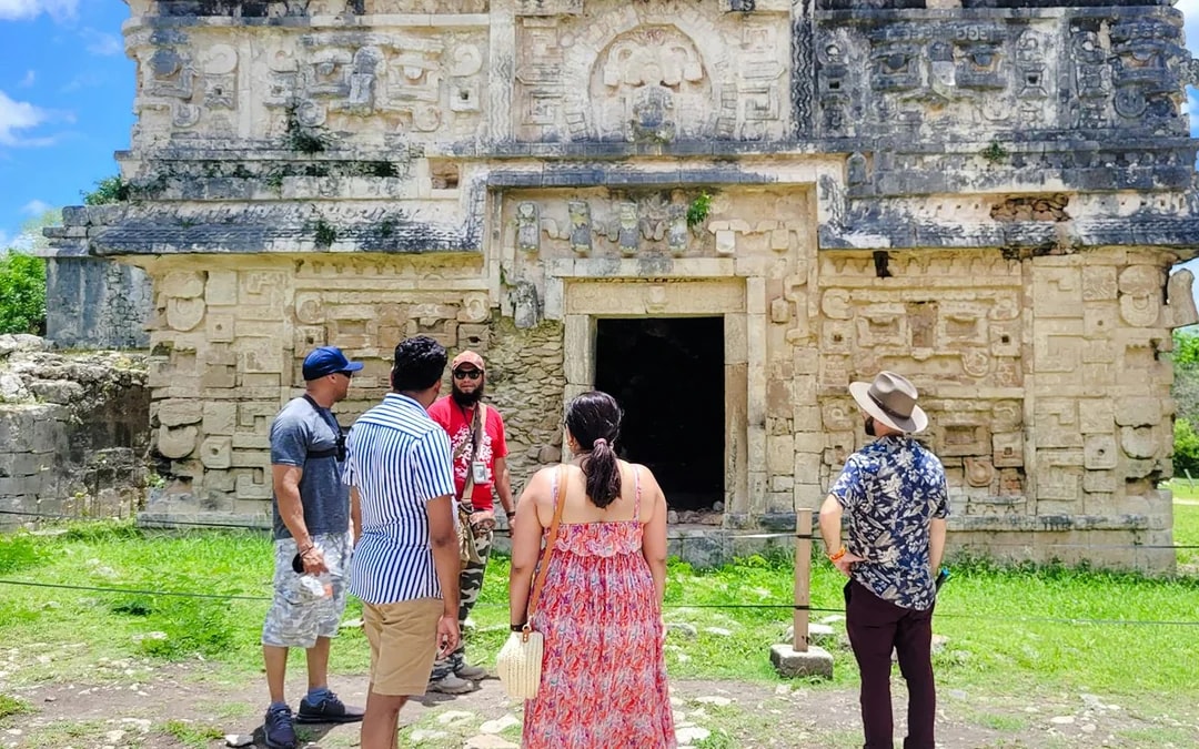 Tourists exploring ancient Mayan ruins at Chichen Itza, Mexico.